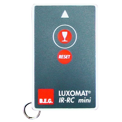 B.E.G. LUXOMAT IR-RC Mini infrarød fjernbetjening med oplyst glas-symbol og reset-knap på grå baggrund.