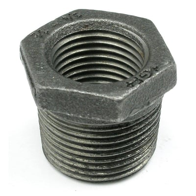 Sort Unico nippmuffe med 1 1/4" udvendigt og 1/2" indvendigt gevind. Muffen har en sekskantet form og tydelige gevinddetaljer.