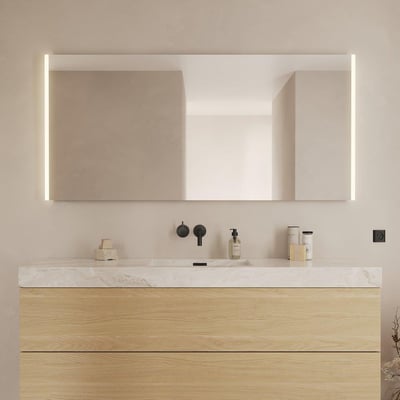 Rektangulært Lago spejl på 160x75 cm med integreret LED-lys langs siderne, monteret over et badeværelsesmøbel med trælåger og marmorbordplade.
