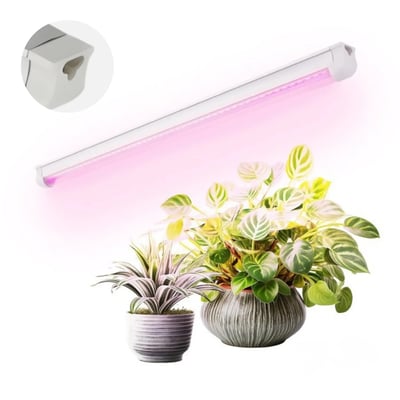 Hvidt Kobi GROWLY LED-vækstlysarmatur på 593 mm og 9 W lyser med pink skær over potteplanter.