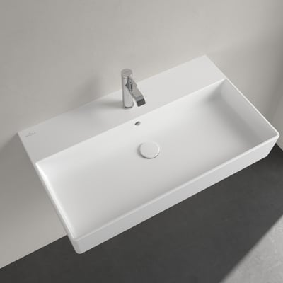 Villeroy & Boch Memento 2.0 håndvask monteret på væg med et krom blandingsbatteri, vist med grå og hvid baggrund.