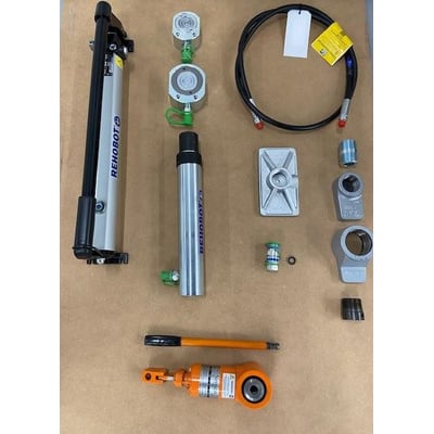 Nike Hydraulik Sæt L-28 med håndpumpe, trykcylindre, slange og diverse tilbehør på en brun baggrund.