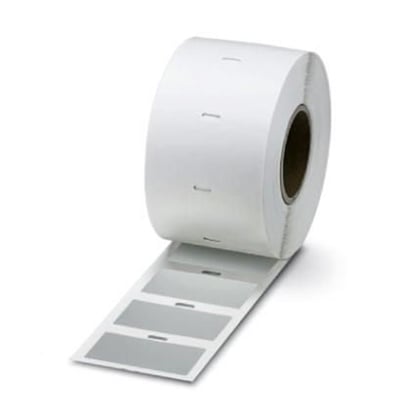 Nærbillede af en rulle Phoenix Contact EML (100X73)R SR etiketter, der viser den sølvfarvede polyesteroverflade og mål på 100 x 73 mm.