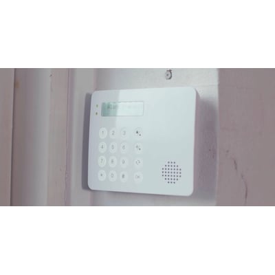 TrueGuard tastatur med LCD display, monteret på en rå væg, viser "Alarm frakoblet" på skærmen.