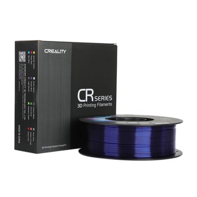 Creality CR-PETG-filament på spole i blå, gennemskinnelig farve ved siden af den sorte emballage.