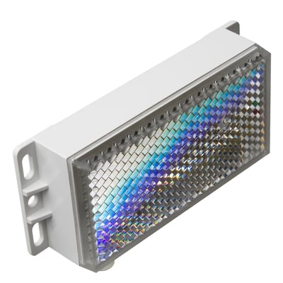 Carlo Gavazzi prismereflektor med varme, 24 VDC og 8 W, set skråt forfra med facetteret refleksflade og monteringsbeslag.