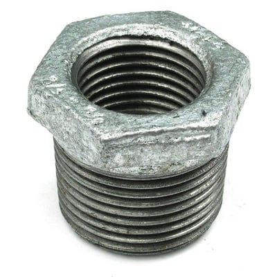 Unico galvaniseret nippelmuffe med gevind, der reducerer fra 1 1/4" til 1/2", på hvid baggrund.