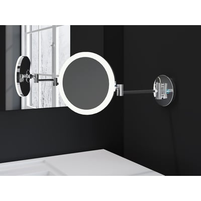 Cosmic vægmonteret makeupspejl med LED-lys i mat sort, med 5x forstørrelse og justerbar lysfarve, monteret på sort væg ved siden af et vindue.