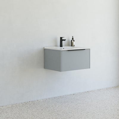 Dansani Mido møbelpakke i glat blå mat, vist monteret på en hvid væg med et terrazzo gulv og minimalistisk badeværelsesæstetik.
