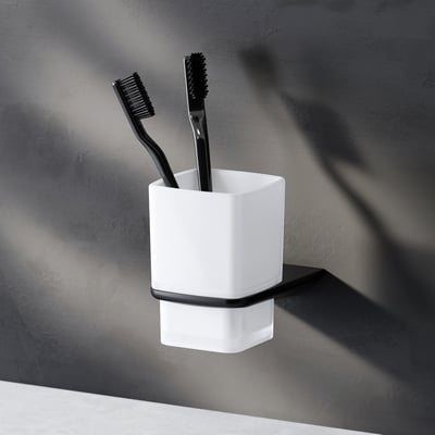 AM.PM Inspire V2.0 tandkrus med holder i mat sort, vist med to sorte tandbørster.
