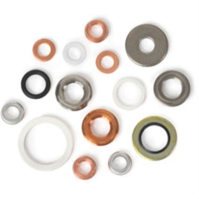 Samling af forskellige pakninger i kobber, gummi, plastik og metal til gevindforbindelser, herunder WIKA 910.17 modellen.
