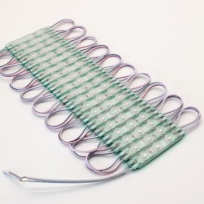 Række af LEDlife grønne LED moduler, slukket, med synlige ledninger og grønne printplader, placeret på hvid baggrund.