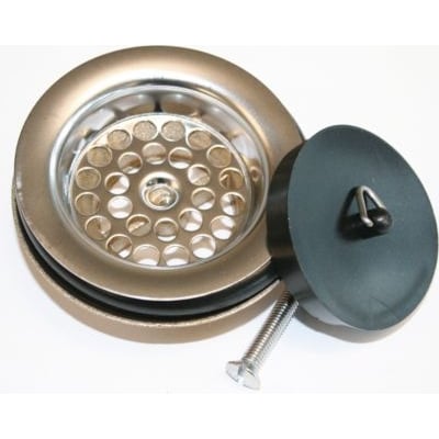 Nærbillede af Viega bundventil dele: messing ventilunderdel med pakninger, rustfri stålsi og sort gummi prop med trekantskrog.