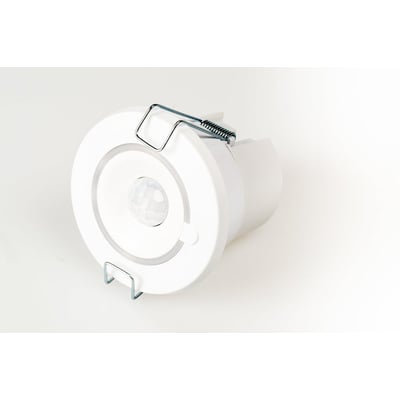 Helvar Digidim320 PIR sensor set fra en vinkel, viser den runde hvide enhed med metalclips og teknisk design.