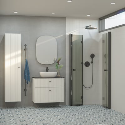 Dansani Pixel greb i sort, 26 mm diameter, vist monteret på et hvidt skab i et moderne badeværelsesmiljø.