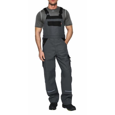 Kansas Icon arbejds-overall i grå/sort, model 100812, vist på en mand med en grå t-shirt, der fremviser lommer og reflekser.