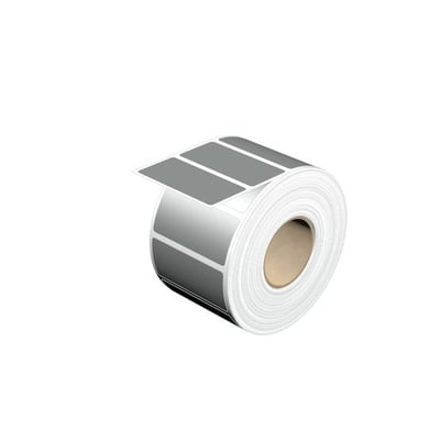 Weidmüllers sølvfarvede THM MT30X 57/27 SI-komponentmærker ses på en rulle med blanke, rektangulære etiketter.