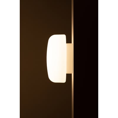 Sideprofil af Ifö Electric Solenne lampe monteret på væg, fremhæver den matte opalglas og hvide base i dæmpet belysning.