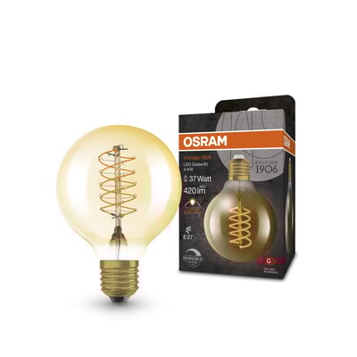 Osram Vintage 1906 globe 80 LED-pære med spiral filament i ravfarvet glas på neutral baggrund, ved siden af æsken.