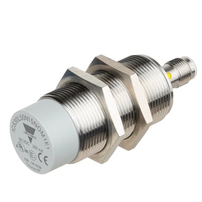 Carlo Gavazzi ICS E1 induktiv sensor i M30-størrelse med rustfrit stålhus og grå front, set skråt fra siden.