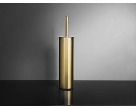 Unidrain Reframe toiletbørste i børstet messing står på en sort bordplade med grå bagvæg.