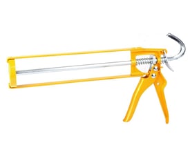 Gul Ironside fugepistol i metal til patroner, set fra siden med håndtag, stempelstang og ophængskrog.