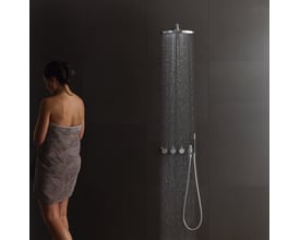 Vola indbygningstermostat med omskifter T2 og ¾'' tilslutning i et moderne badeværelse med en kvinde svøbt i et håndklæde.