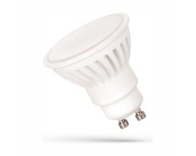 SpectrumLED GU10 LED-pære på 10 W med hvid keramisk krop og to metalstifter, set skråt forfra.