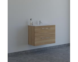 Dansani Mido mini møbelpakke i varm eg monteret på en lysegrå væg med kromarmatur og sæbedispenser.