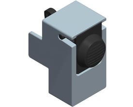 Schneider Electric lås til adapter, trykknap med sort drejeknap og grå klemme på hvid baggrund.