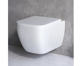 AM.PM Gem væghængt toilet i hvid, kompakt design med sæde-cover, monteret på betonvæg.