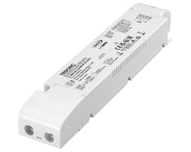 Tridonic LED driver LC 60W 24V DALI-2 one4all NF SC EXC2 SP i hvidt plast med tydelig mærkning og tilslutningsklemmer på en hvid baggrund.