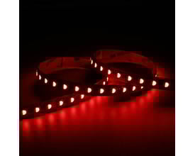 Ansell Lighting P-Cell LED bånd på 10 meter, der lyser rødt med synlige LED-dioder og 3M tape på bagsiden mod mørk baggrund.