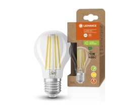 Ledvance LED standard fil pære med klar glasoverflade og synlige filamenter, der giver 1055lm og 5W, med E27 sokkel, præsenteret ved siden af dens papemballage.