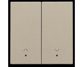 Niko smart motorbetjeningstangent i champagnefarve med dobbelttryksknap og linse samt pileikoner. Fremstår neutral og stilren.