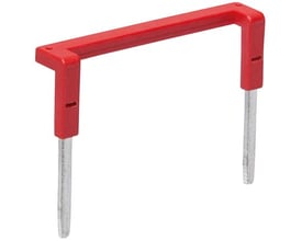 Rød jumper med to metalben og et firkantet rødt plasthåndtag til elektrisk forbindelse.