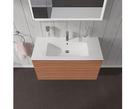 Duravit L-Cube vaskeskab i valnød natur med integreret hvid porcelænsvask monteret på en træbeklædt væg.