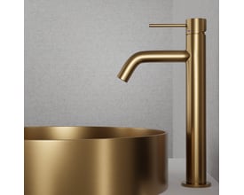 Scandtap Steel Voyage High håndvaskarmatur i børstet messingfarvet stål, monteret på en messingfarvet håndvask.