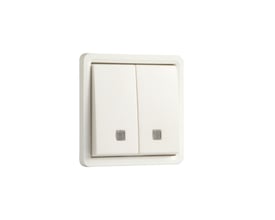 Niko dobbelt fjedertryk i hvid med linse til LED-element, IP55 klassificeret og slagfast, monteret på en hvid baggrund.