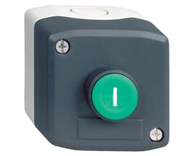 Schneider Electric trykkasse XALD102 set fra en let skrå vinkel, viser gråt kabinet med grønt betjeningsknap.