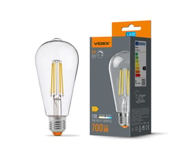 Videx dæmpbar ST64-filament LED-pære med E27-fatning, 6 W og klart glas vist ved siden af emballagen.