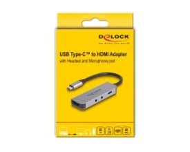 DeLock USB-C-adapter til HDMI med headset- og mikrofonport ses på den gule produktemballage.