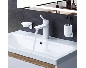 AM.PM X-Joy S et-grebs håndvaskarmatur i mat hvid funktionelt monteret på en hvid håndvask med rindende vand.