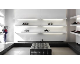 Ansell Lighting H-Cell LED bånd, 5 meter, 3000K varmt hvidt lys og IP67-klassificering, præsenteret i en moderne butiksindretning med hylder og sko.