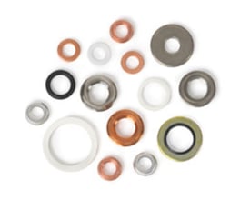 Samling af forskellige pakninger i kobber, gummi, plastik og metal til gevindforbindelser, herunder WIKA 910.17 modellen.