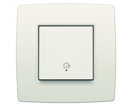 Niko 'forlad hjem'-tryk i hvid til Niko Home Control med integreret sensor og hus-symbol på en cremefarvet ramme.