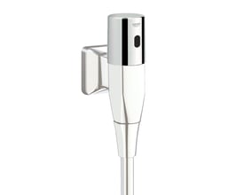 Grohe Tectron urinal overdel med krom finish monteret på en hvid væg, med synlig sensor og batteridæksel.