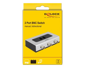Emballagen til DeLock manuel, bidirektionel BNC-switch med to porte viser en illustration af den sølvfarvede switch.