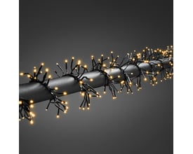 Nærbillede af Konstsmide lyskæde med 1152 amber lys, der er viklet omkring et sort rør med ensartet glød.