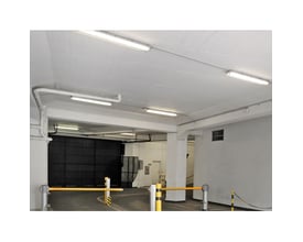 Dobbeltarmatur med Limea T8 LED-rør, 24 W og 150 cm, monteret i loftet i et parkeringsområde.
